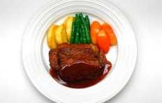 Replica of beef steak with wine sauce and vegetables