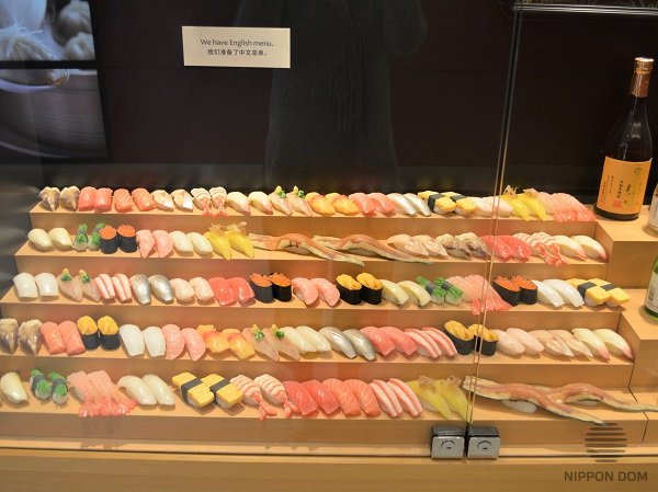 Stairs-shaped display window of sushi bar: visitors see the whole assortment of the menu; it is convenient to study meals and choose an order. 