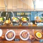 Restaurant display with food replicas and clear claims like 100% beef to build trust