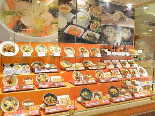 Large menu item photos at back of showcase clearly visible to attract customers
