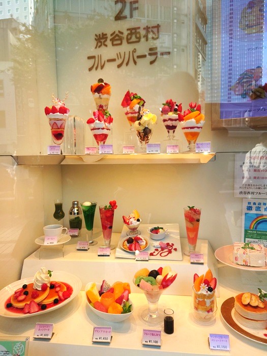 Replica desserts decorated with fruits and berries to enhance showcase appeal