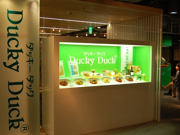 Fake food showcase in warm bright colors red orange yellow green highlighting budget café pricing