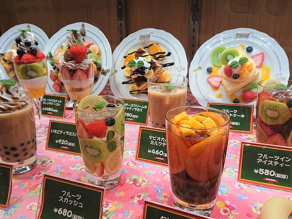 Beverage replica with fake fruit pieces arranged in a cup for café display
