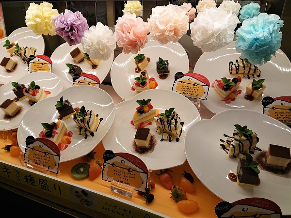 Bright food replica showcase design with fruit and floral details