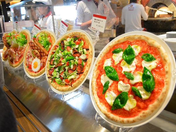 Fake pizza replicas in food court showcase helping guests choose faster