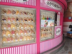 Customers choosing from food replica display while waiting in line to speed up service