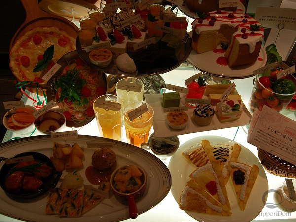 Food replicas in showcase with insufficient lighting making dishes look dull