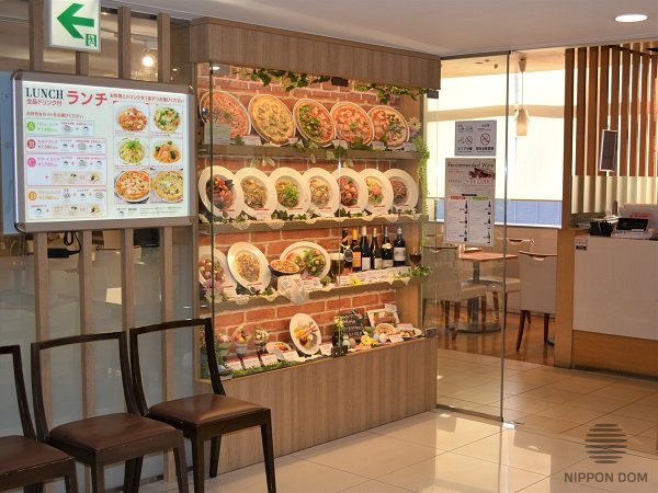 Chairs at restaurant entrance for guest comfort while waiting for table