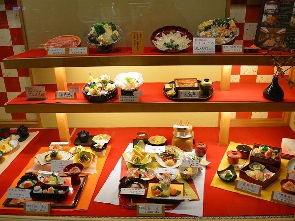 Red display window of Japanese restaurant showcasing authentic food replicas