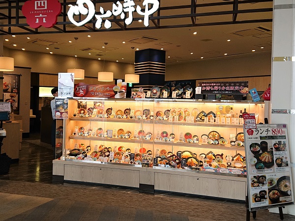 Wide assortment of food replicas in restaurant showcase to attract visitors