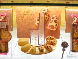 Showcase with bright lighting highlighting cake replicas for attractive display
