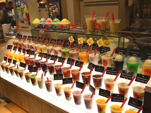 Tapioca dessert replicas in three cup sizes displayed on top shelf for customer choice