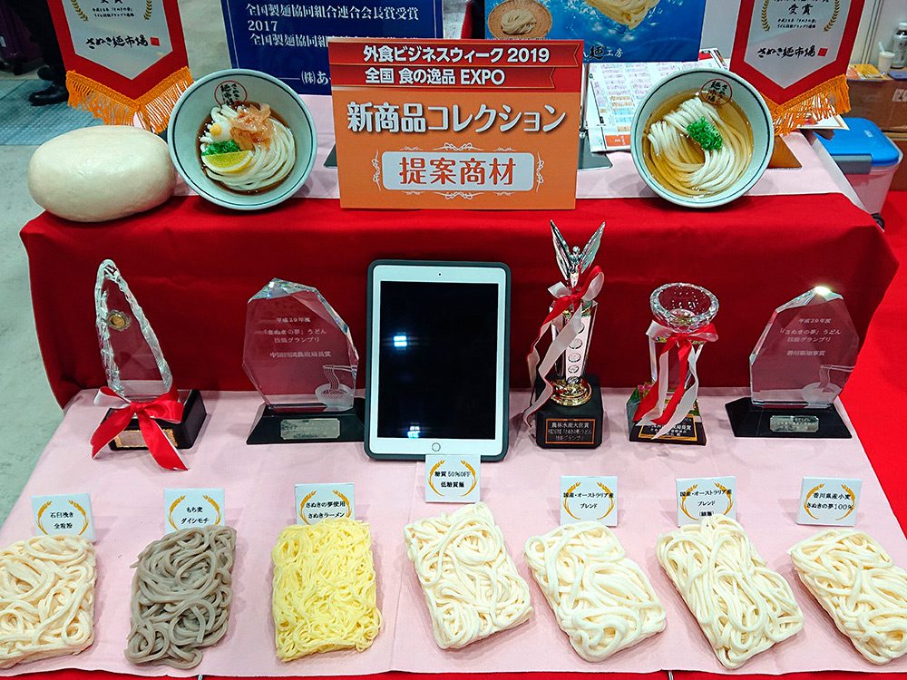 Trade show food display with noodle replicas presenting a supplier range to buyers