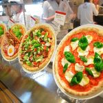 menu display for pizzerias with pizza replicas in food court