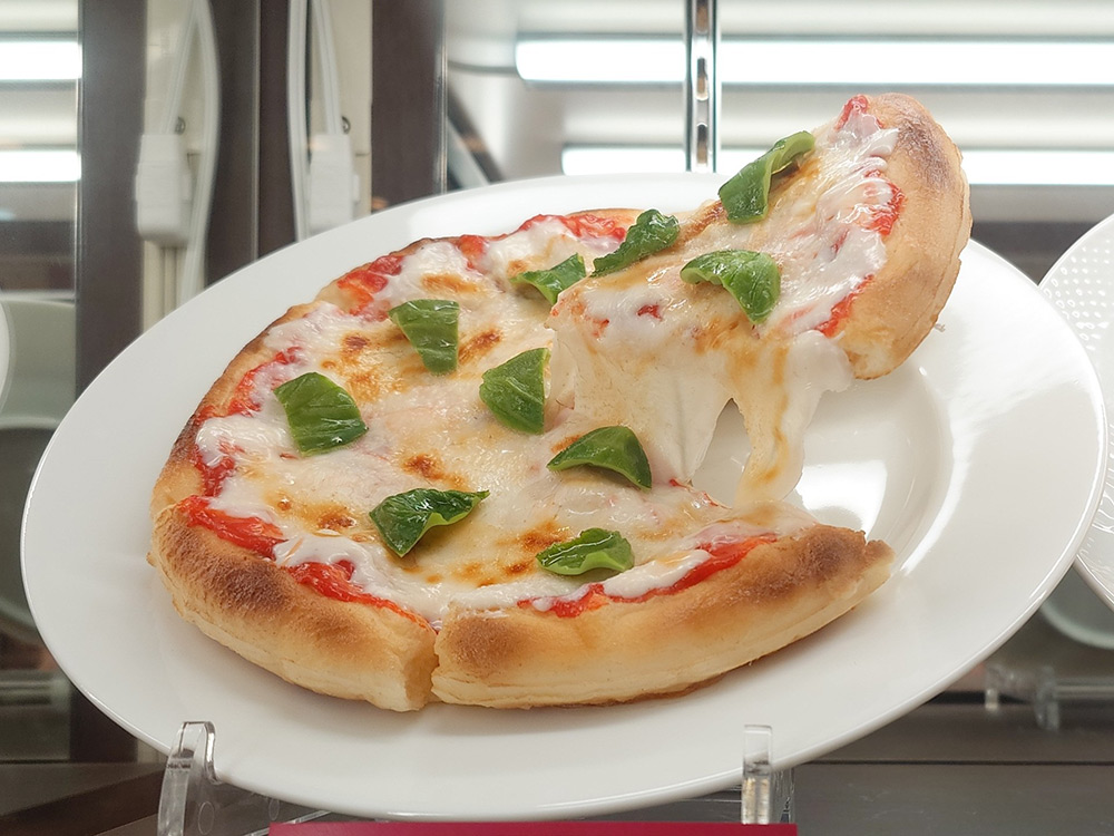 Pizza food replica with a lifted slice showing frozen motion effect