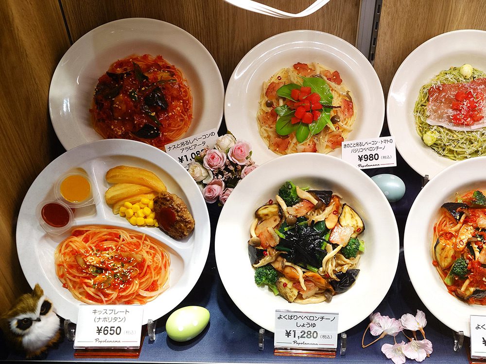 Restaurant window display where kids menu replicas do not visually stand out among adult dishes