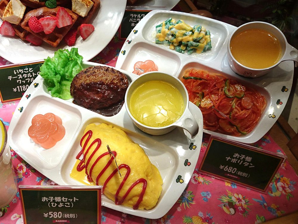 Italian restaurant window display with several kids menu food replicas offering variety