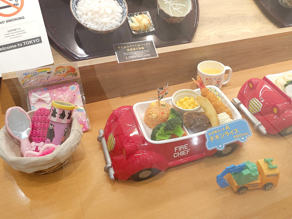 Kids Napolitan pasta in an Italian family restaurant with a small British flag and complimentary juice packs, illustrating why restaurants need a kids menu as a low-price entry point