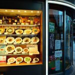 Abundant food display in an illuminated restaurant window seen from the street