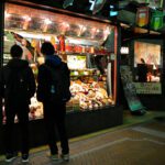 A brightly lit window on a Tokyo street at night — proof that restaurant window display lighting is what stops passers-by