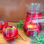 Sangria pitcher and glasses replicas on a wooden board, drink display ideas