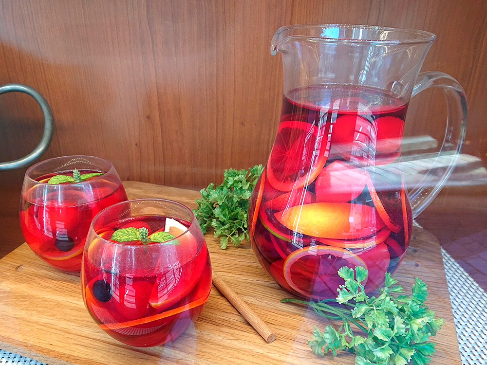 Sangria pitcher and glasses replicas on a wooden board, drink display ideas