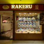 Restaurant window display ideas: lit omurice replicas on four shelves beside the entrance