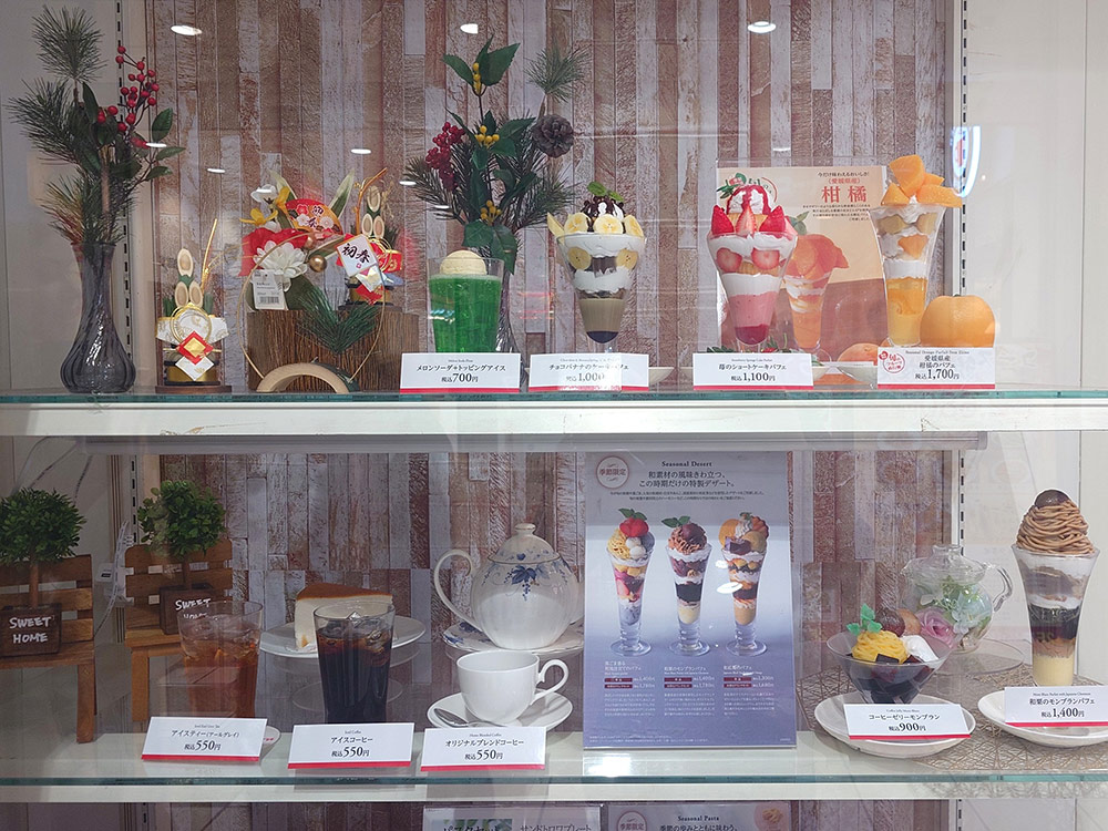 Cafe shelves with New Year decorations, parfait models and drink samples