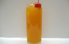 Orange juice decorated with a cherry